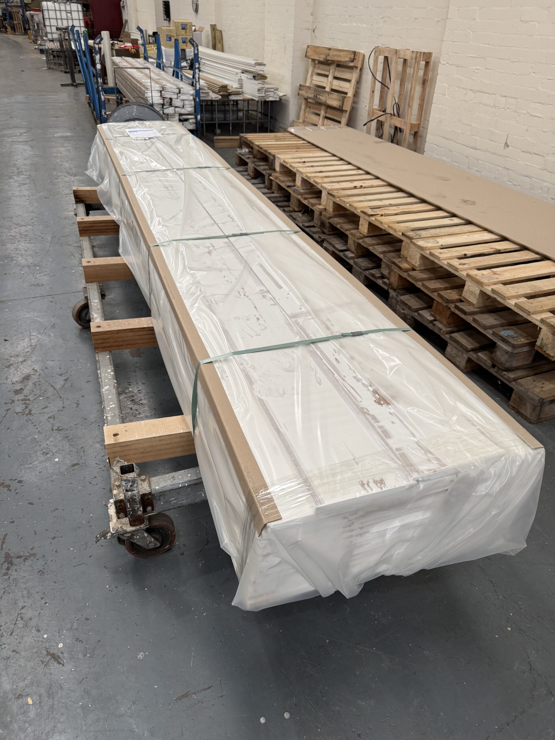 A bundle of skirting board wrapped and strapped for transit