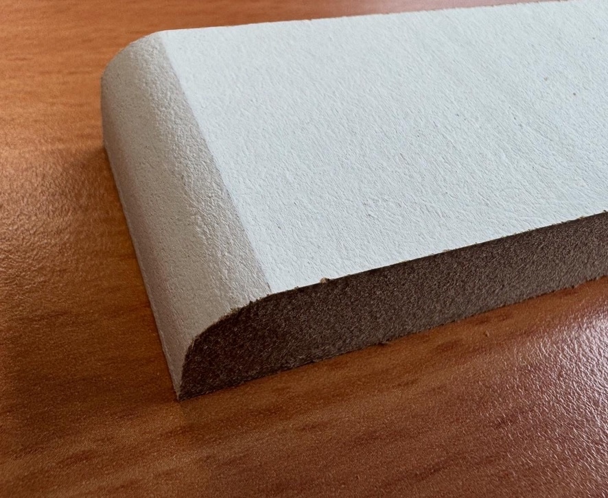 Close-up of factory-primed MDF skirting board